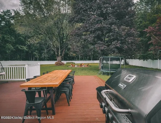 a view of a deck with a trees and wooden fence