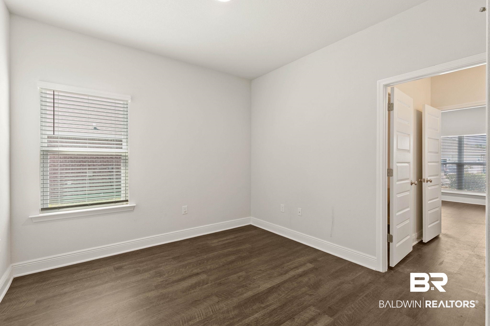 9448 Amethyst Drive Daphne, AL 36526 - Photo 34 of 61 Unfurnished bedroom with baseboards and dark wood finished floors