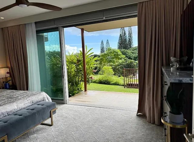 a bedroom with furniture and a floor to ceiling window