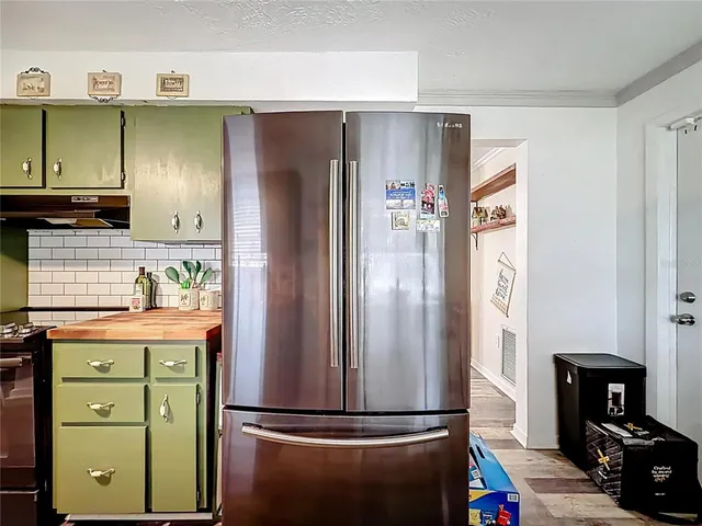 a kitchen with stainless steel appliances granite countertop a refrigerator and a stove