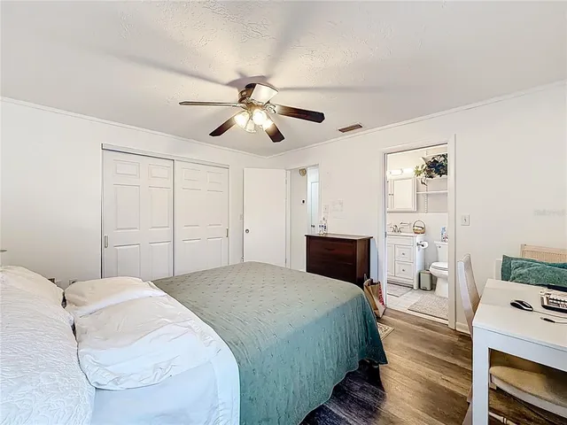 a bedroom with a bed and a tv