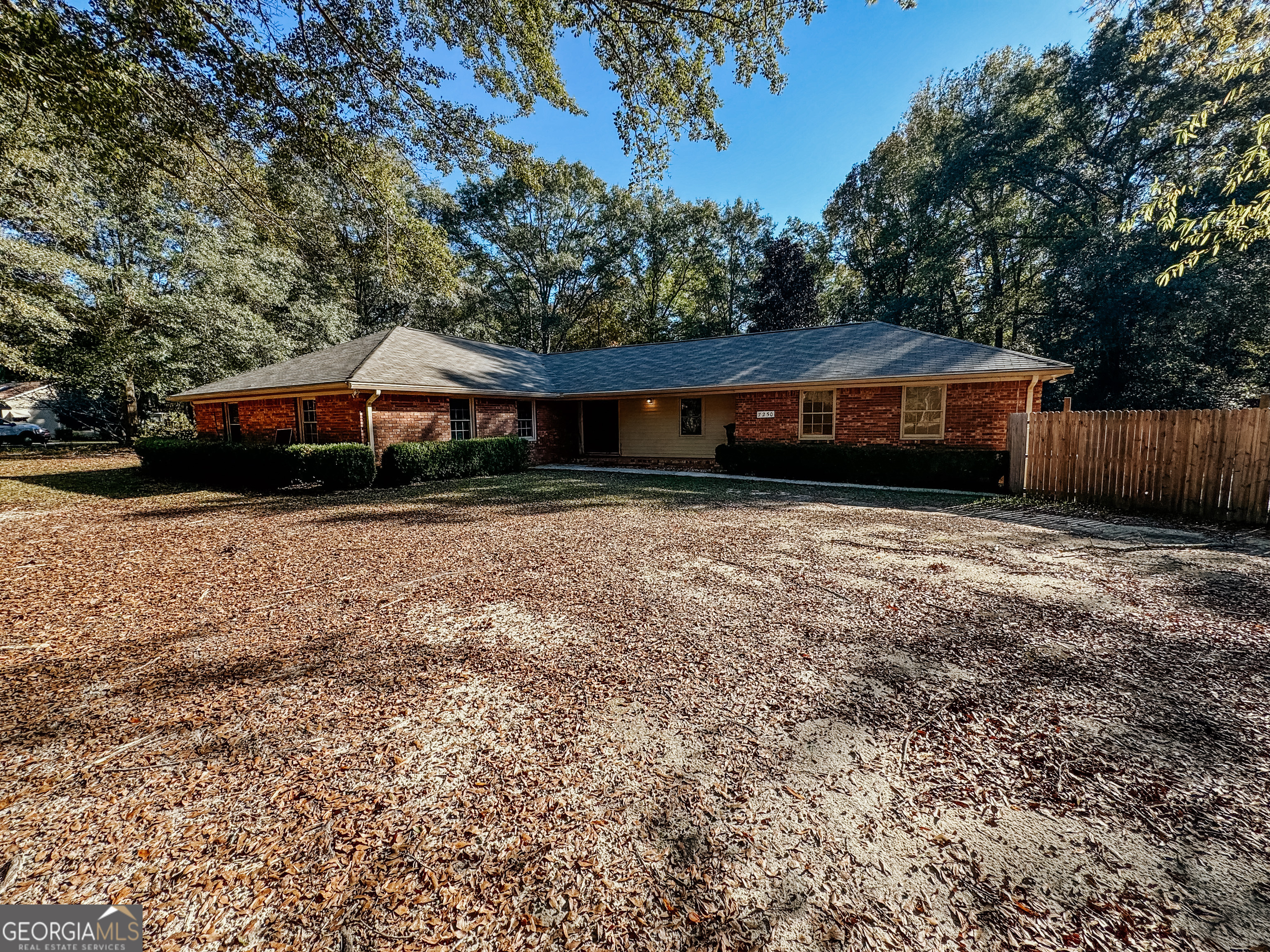 7250 Columbus Road Lizella, GA 31052 - Photo 1 of 1 a house with trees in the background