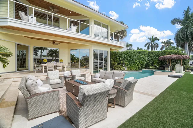 a view of a chairs and table in the backyard of the house