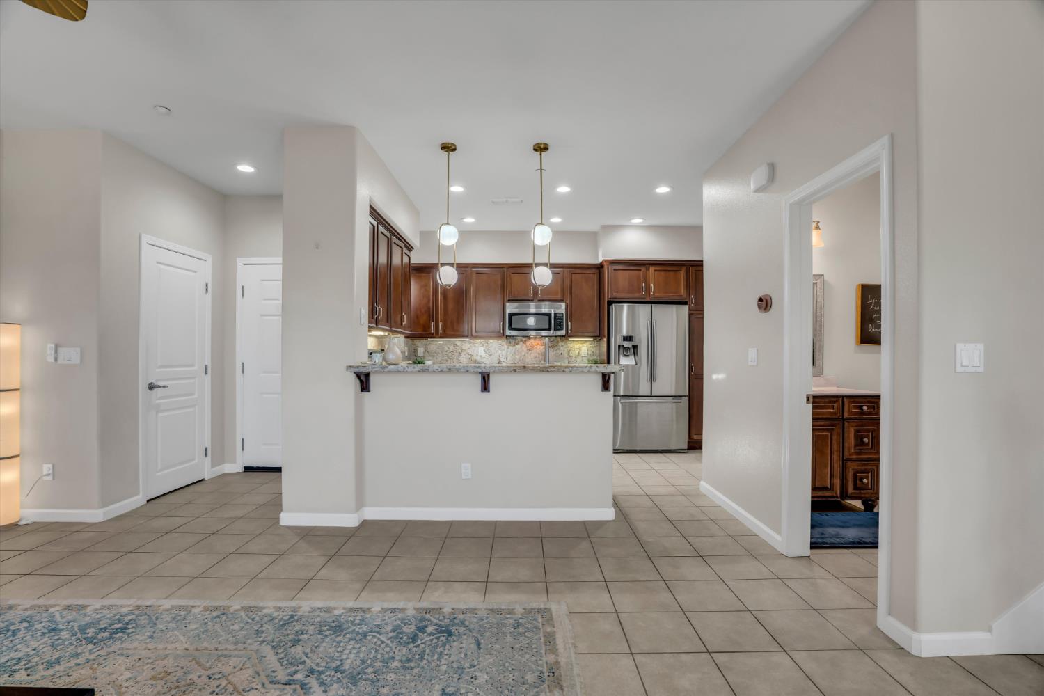 62 South Rio Rapido Drive Tracy, CA 95391 - Photo 14 of 40 a view of kitchen with refrigerator and white cabinets