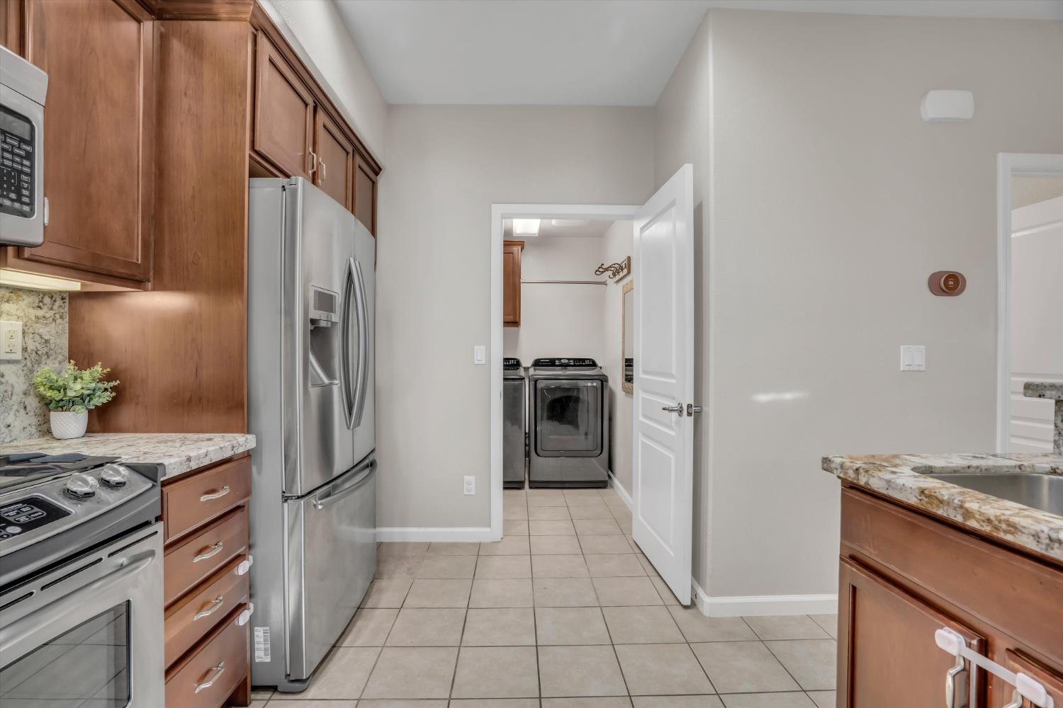 62 South Rio Rapido Drive Tracy, CA 95391 - Photo 17 of 40 a kitchen with a refrigerator a sink and a stove