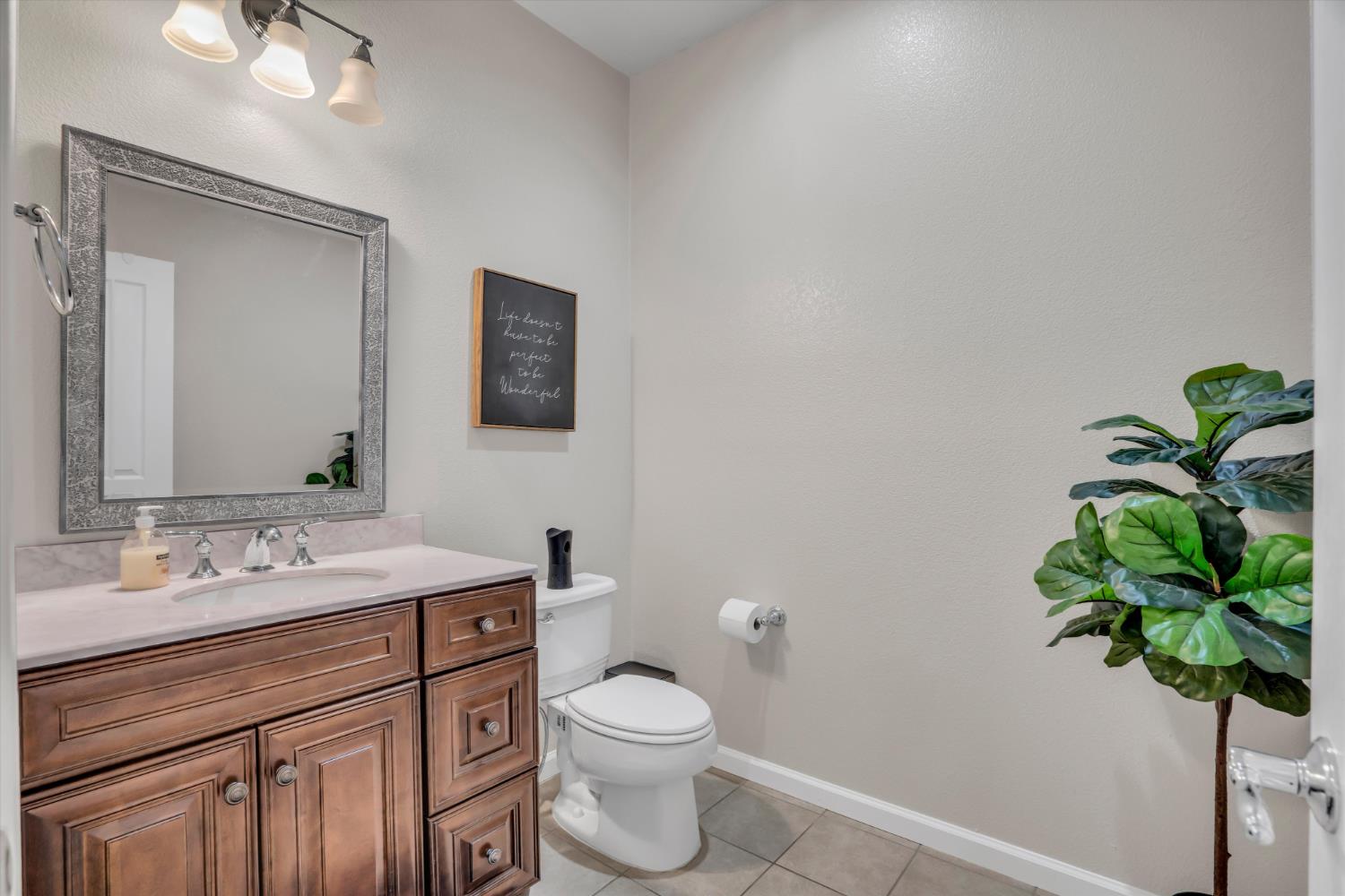 62 South Rio Rapido Drive Tracy, CA 95391 - Photo 19 of 40 a bathroom with a sink a toilet and a mirror