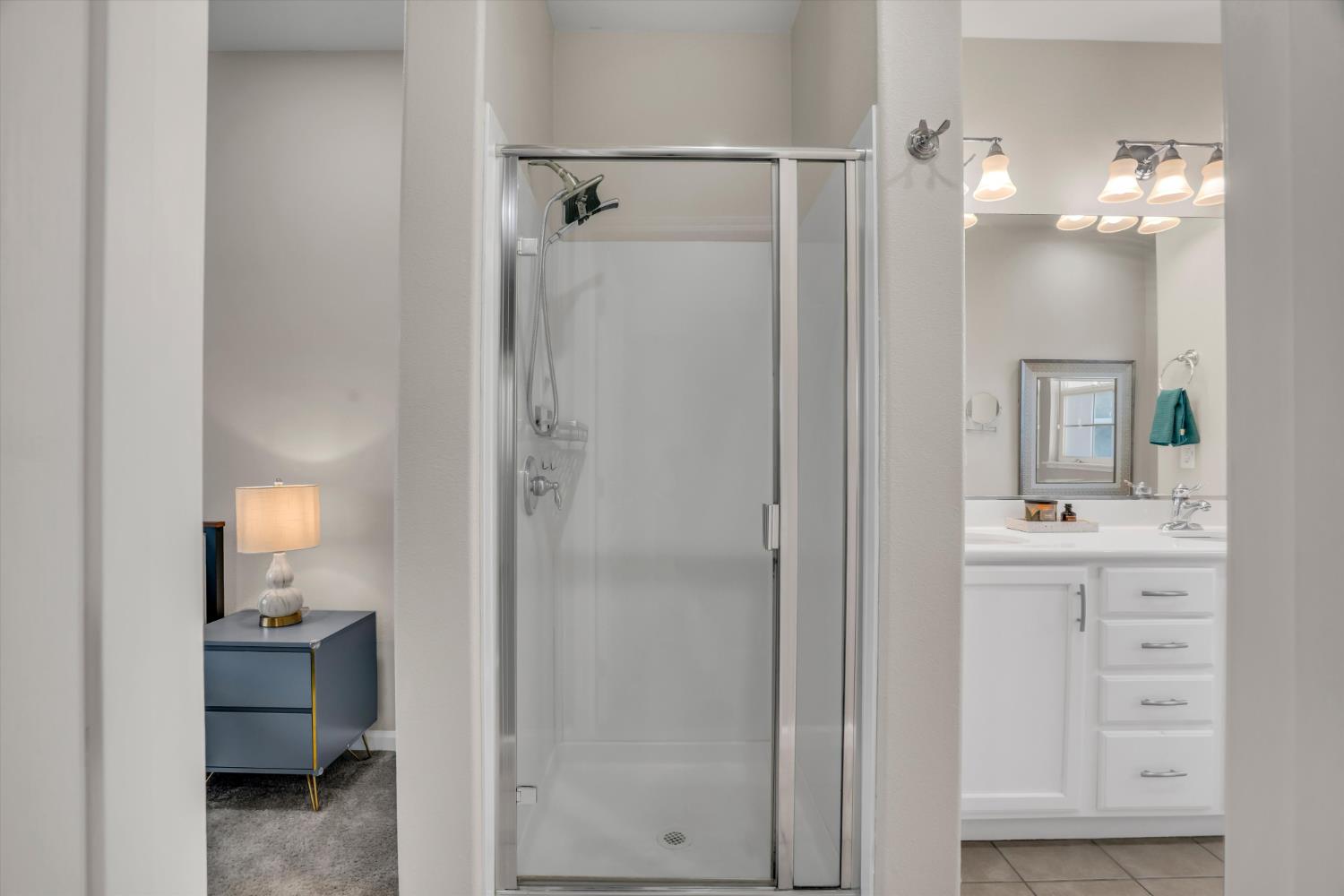 62 South Rio Rapido Drive Tracy, CA 95391 - Photo 28 of 40 a bathroom with a granite countertop sink a mirror and a shower
