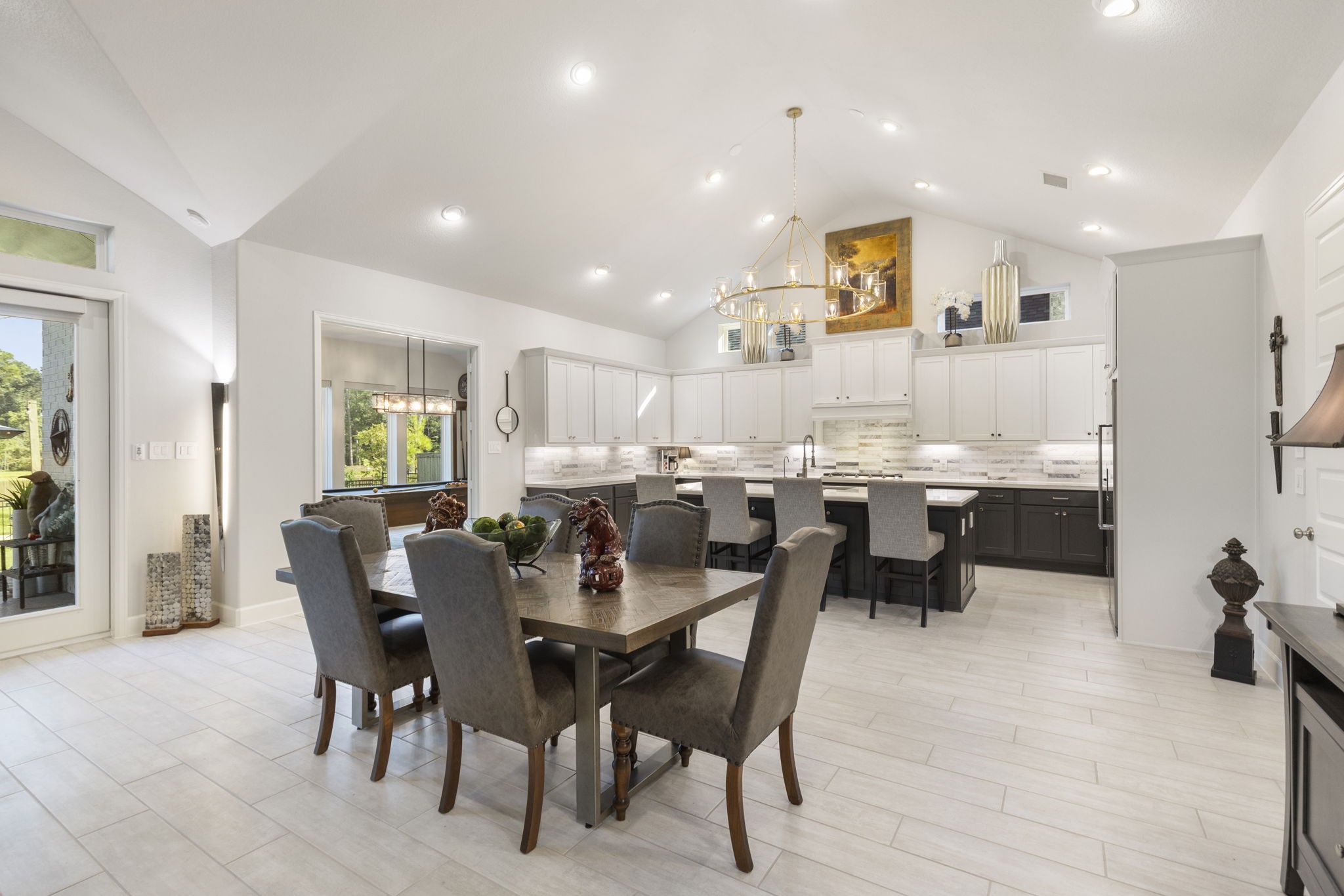 15423 Ringbill Way Magnolia, TX 77354 - Photo 12 of 50 a dining room with stainless steel appliances kitchen island granite countertop a dining table and chairs