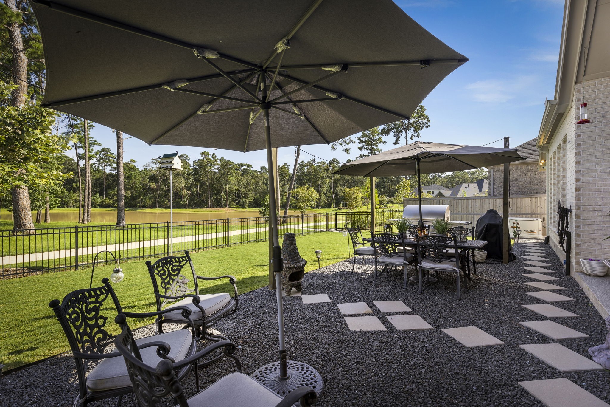 15423 Ringbill Way Magnolia, TX 77354 - Photo 46 of 50 a view of a swimming pool with a table and chairs under an umbrella