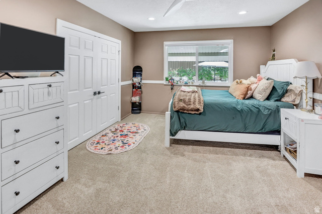 1350 Canyon Park Road Bountiful, UT 84010 - Photo 23 of 38 Carpeted room with neutral-toned walls, featuring a window with exterior views, white paneled double doors, recessed lighting, and a ceiling fan