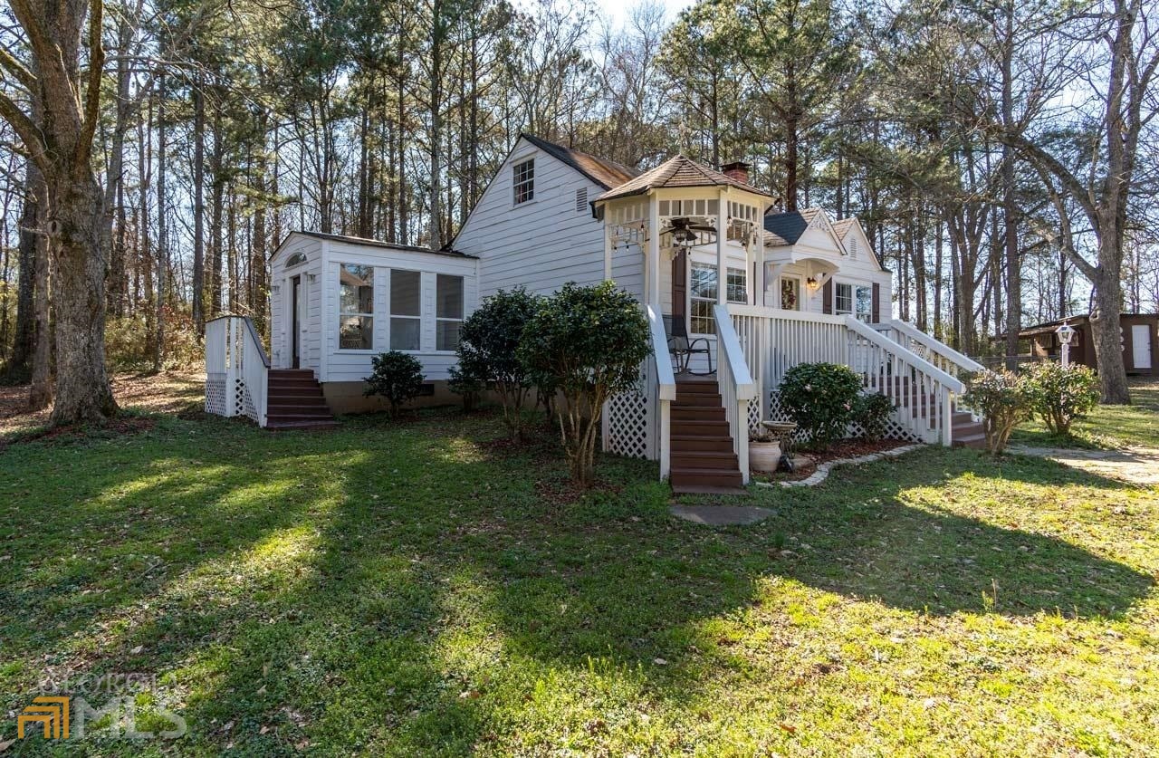 2294 Hampton Locust Grove Road Locust Grove, GA 30248 - Photo 1 of 1 a front view of a house with a garden and trees