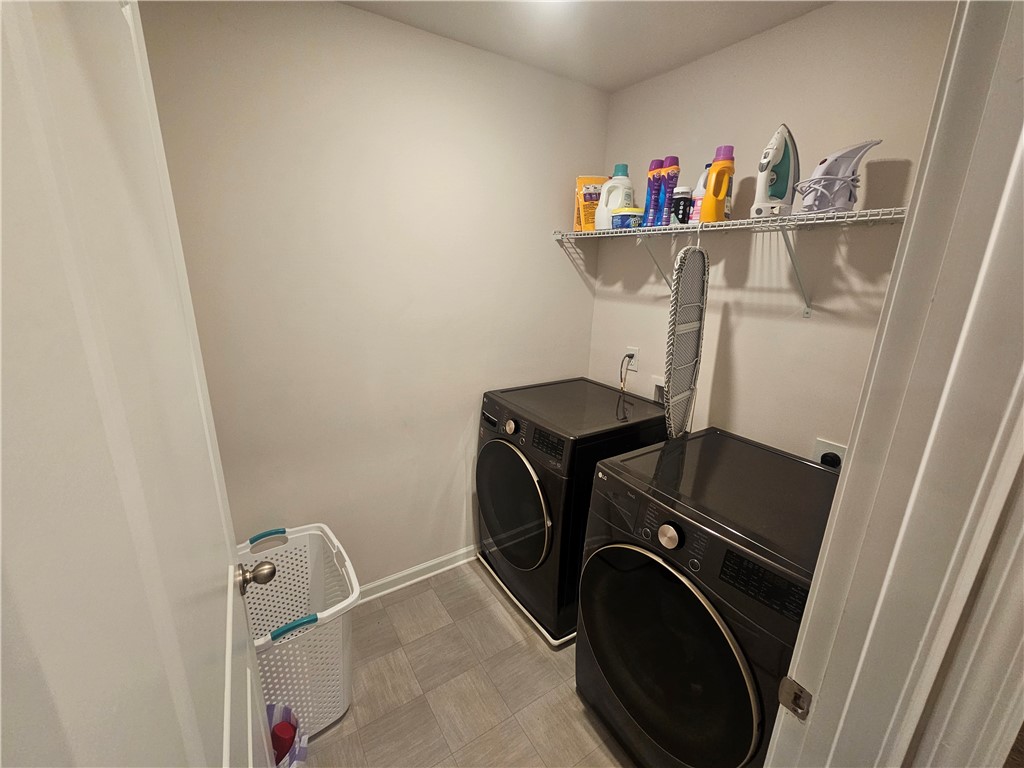 902 Ashwood Lane Easley, SC 29640 - Photo 33 of 39 A dedicated utility space with contemporary laundry appliances and practical overhead shelving.