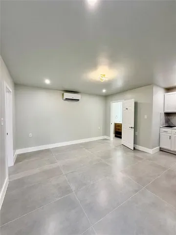a view of a big room with refrigerator and bathroom