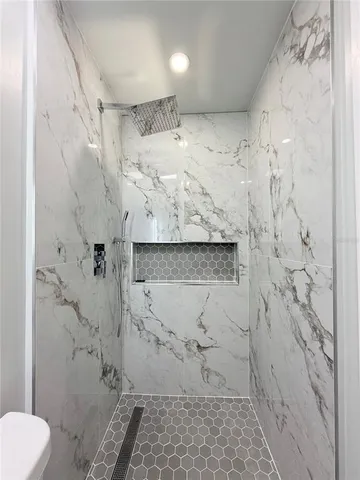 a close view of a sink and dishwasher with kitchen island