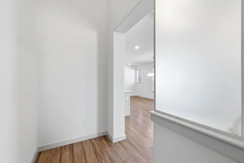 a view of a room with wooden floor