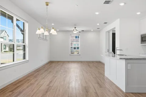 a view of kitchen and hallway with wooden floor