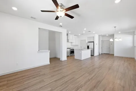 a view of a kitchen with wooden floor and a kitchen space