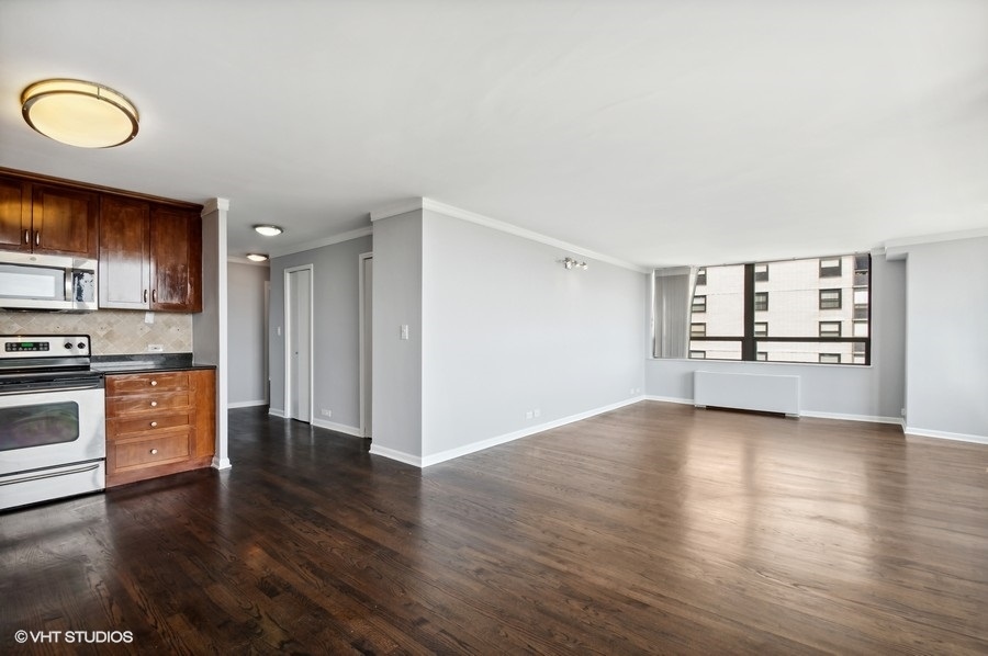 5701 North Sheridan Road, Unit 5T Chicago, IL 60660 - Photo 12 of 27 a view of a kitchen cabinets and wooden floor