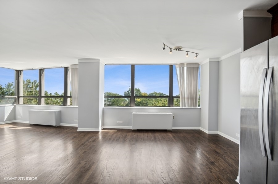 5701 North Sheridan Road, Unit 5T Chicago, IL 60660 - Photo 13 of 27 a view of an empty room with wooden floor and a window