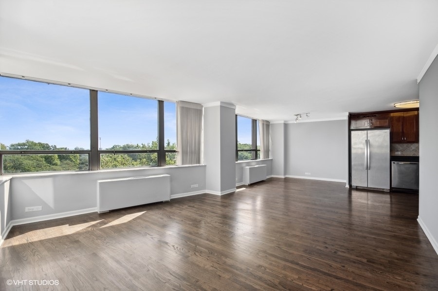 5701 North Sheridan Road, Unit 5T Chicago, IL 60660 - Photo 7 of 27 a view of an empty room with a window and wooden floor