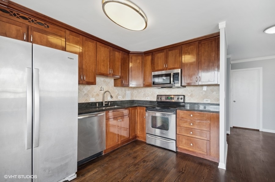 5701 North Sheridan Road, Unit 5T Chicago, IL 60660 - Photo 8 of 27 a kitchen with stainless steel appliances granite countertop a stove a sink and a refrigerator