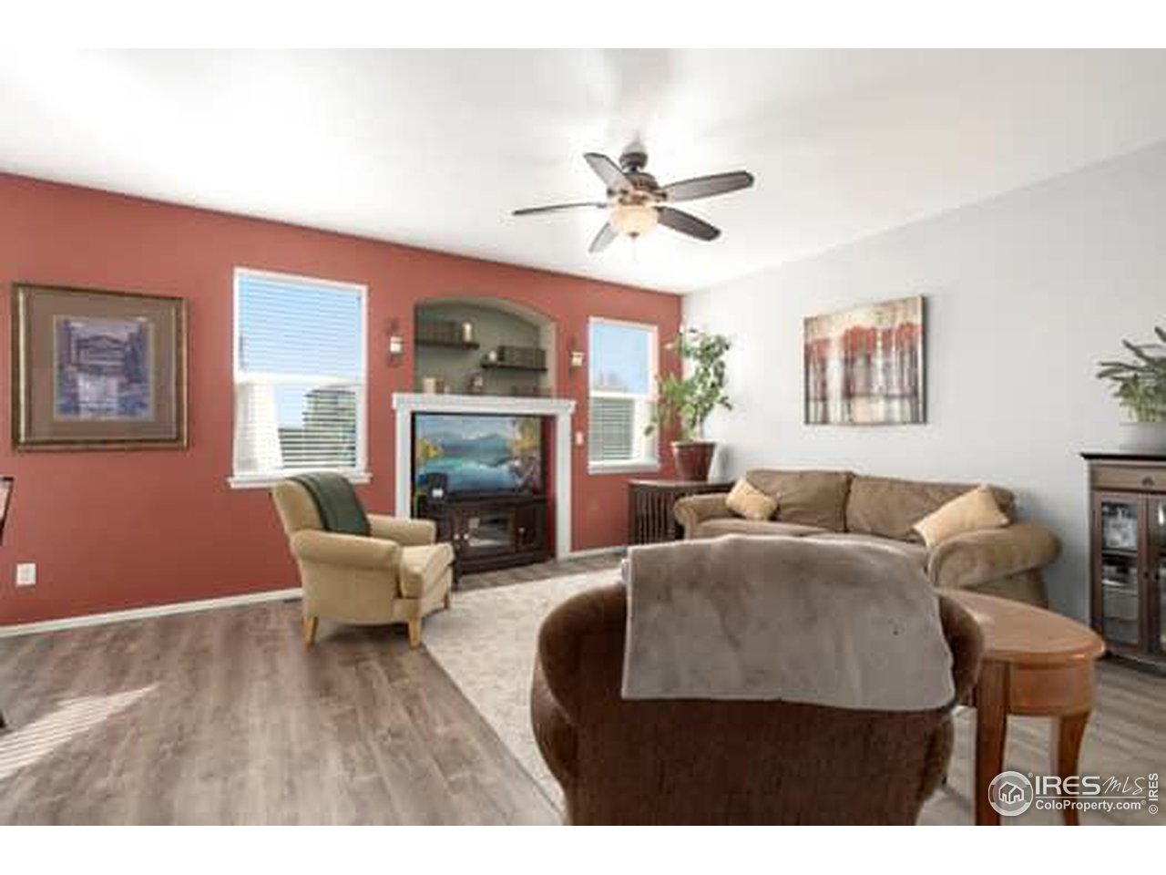 1545 Edenbridge Drive Windsor, CO 80550 - Photo 11 of 28 a living room with furniture a fireplace and a flat screen tv