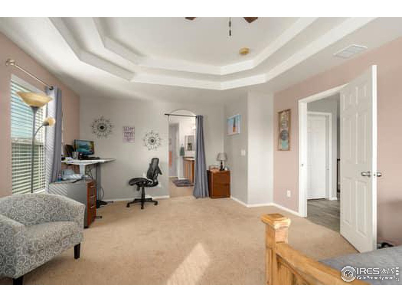 1545 Edenbridge Drive Windsor, CO 80550 - Photo 13 of 28 a living room with furniture and a chandelier