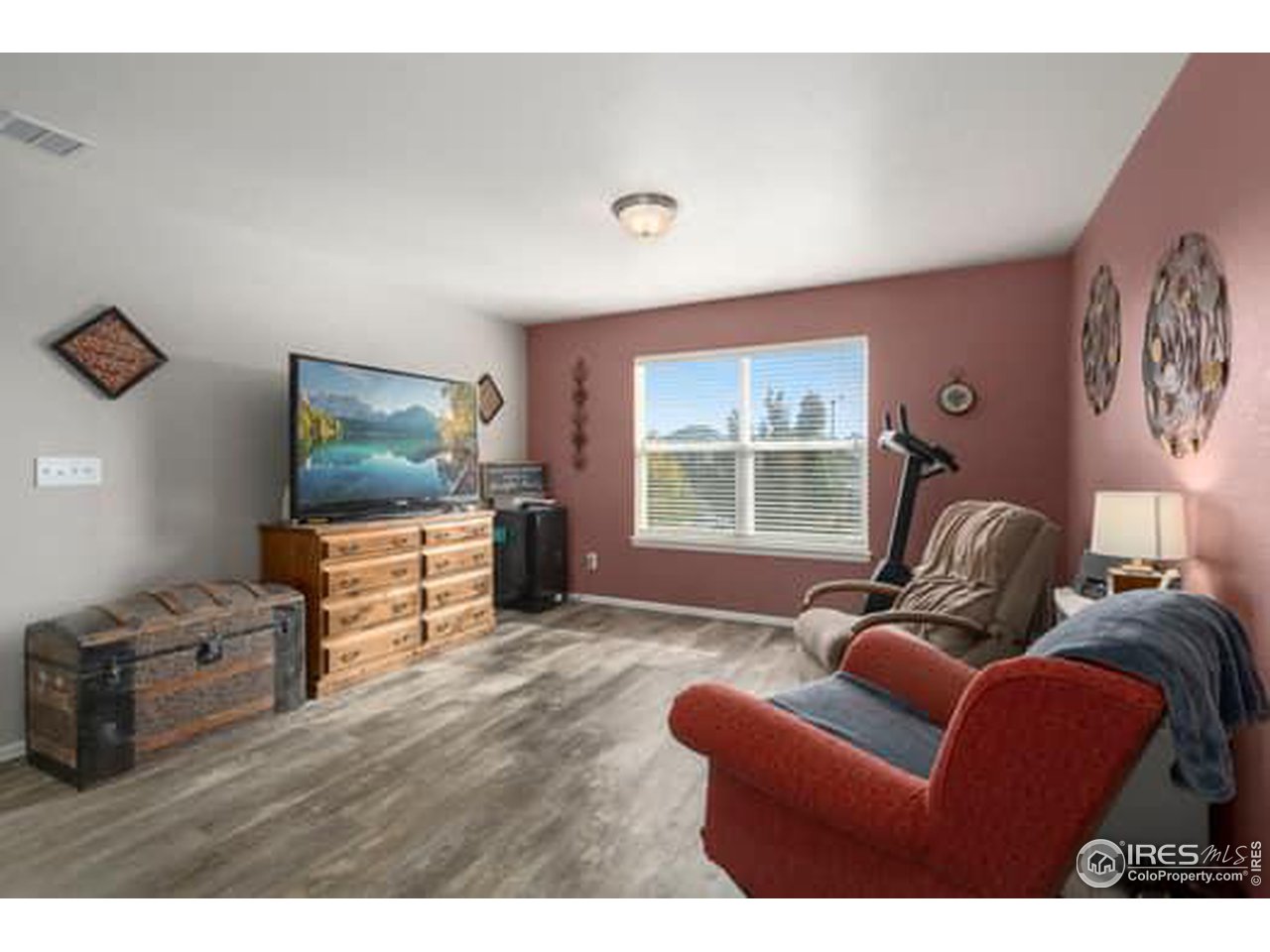 1545 Edenbridge Drive Windsor, CO 80550 - Photo 15 of 28 a living room with furniture and a flat screen tv