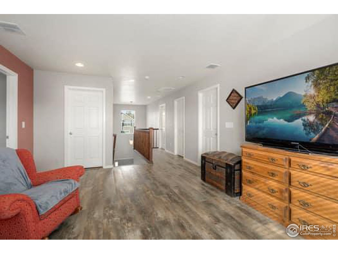 1545 Edenbridge Drive Windsor, CO 80550 - Photo 16 of 28 a living room with furniture and a flat screen tv