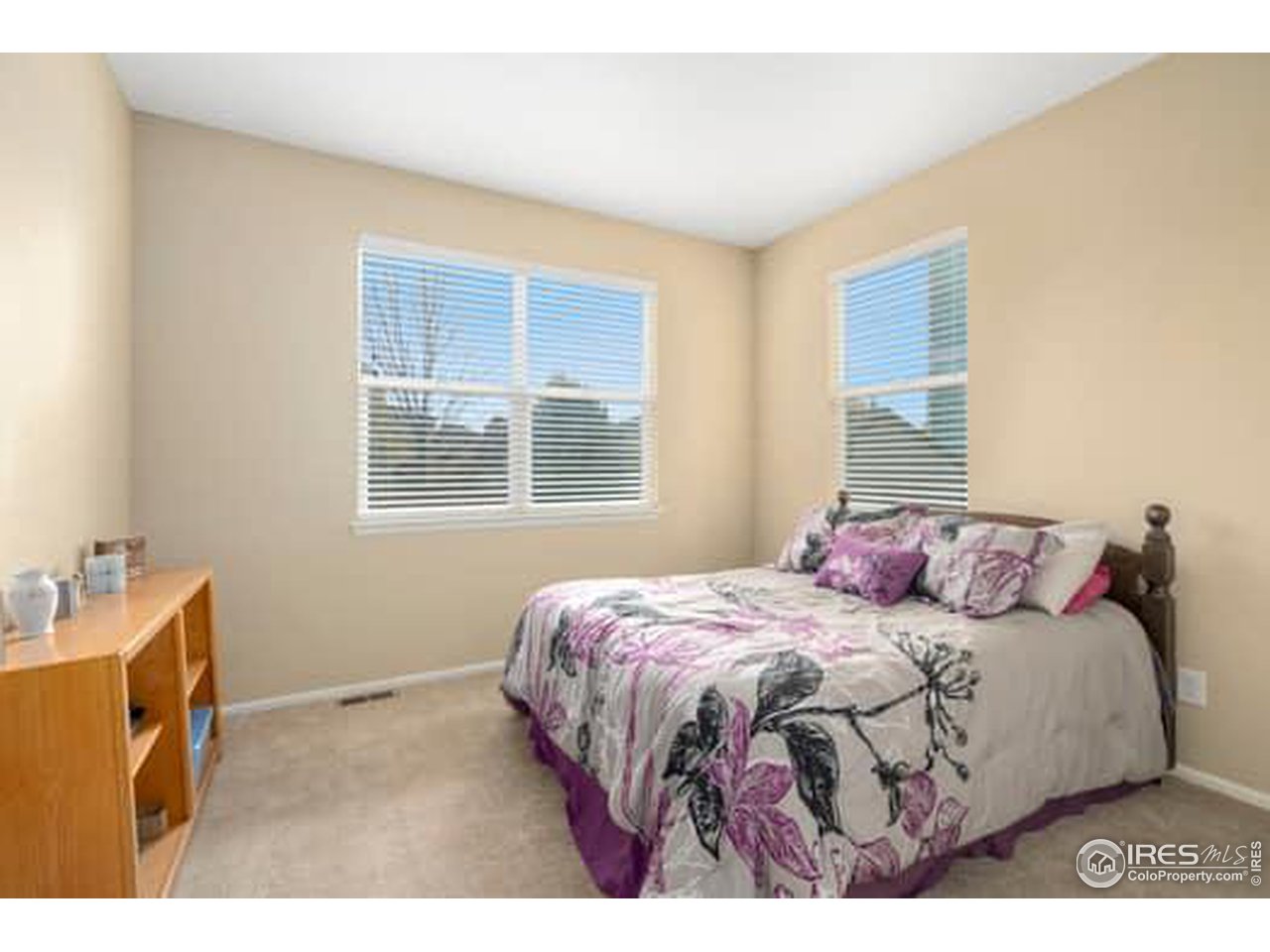 1545 Edenbridge Drive Windsor, CO 80550 - Photo 17 of 28 a bedroom with a bed and wooden floor