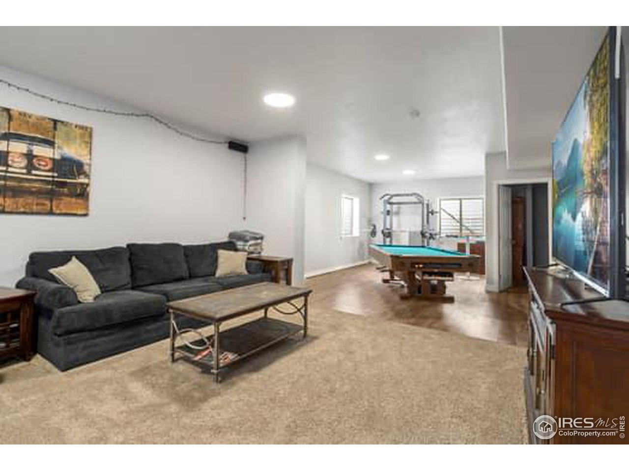 1545 Edenbridge Drive Windsor, CO 80550 - Photo 19 of 28 a living room with furniture and a dining table with kitchen view