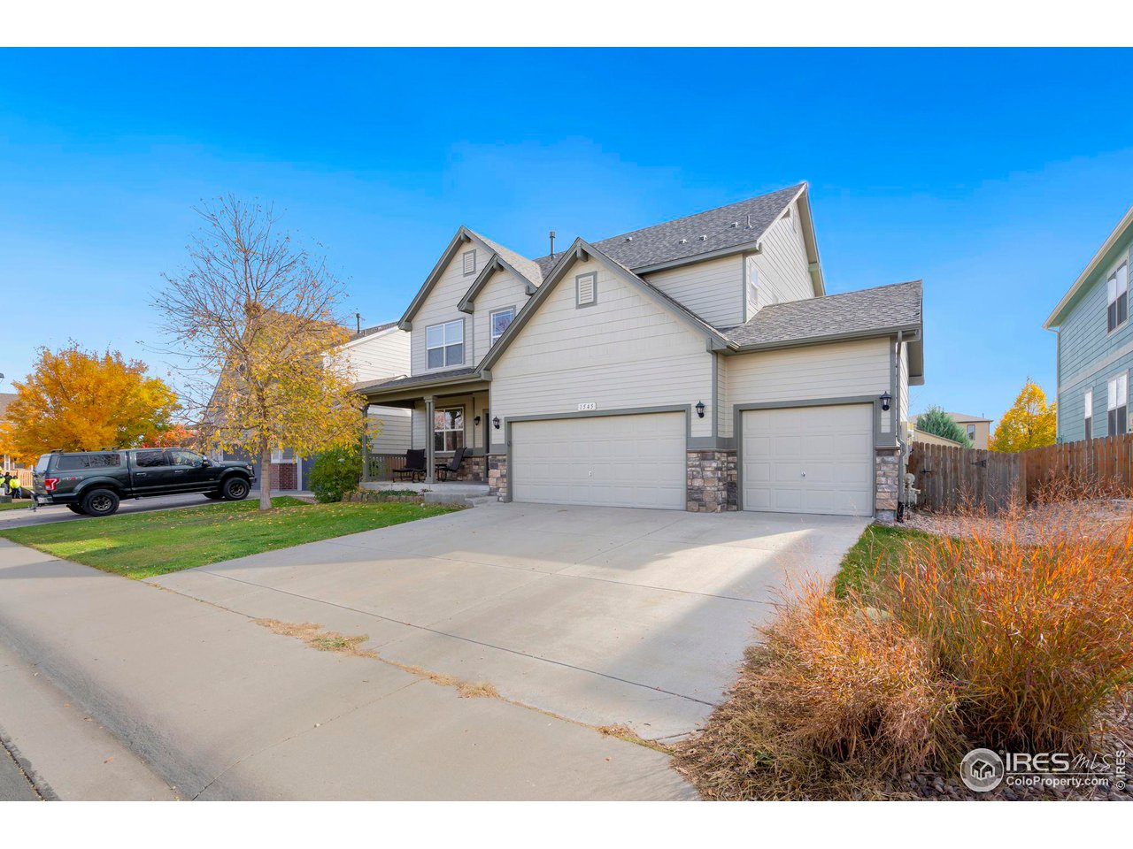 1545 Edenbridge Drive Windsor, CO 80550 - Photo 2 of 28 a front view of a house with a yard and garage