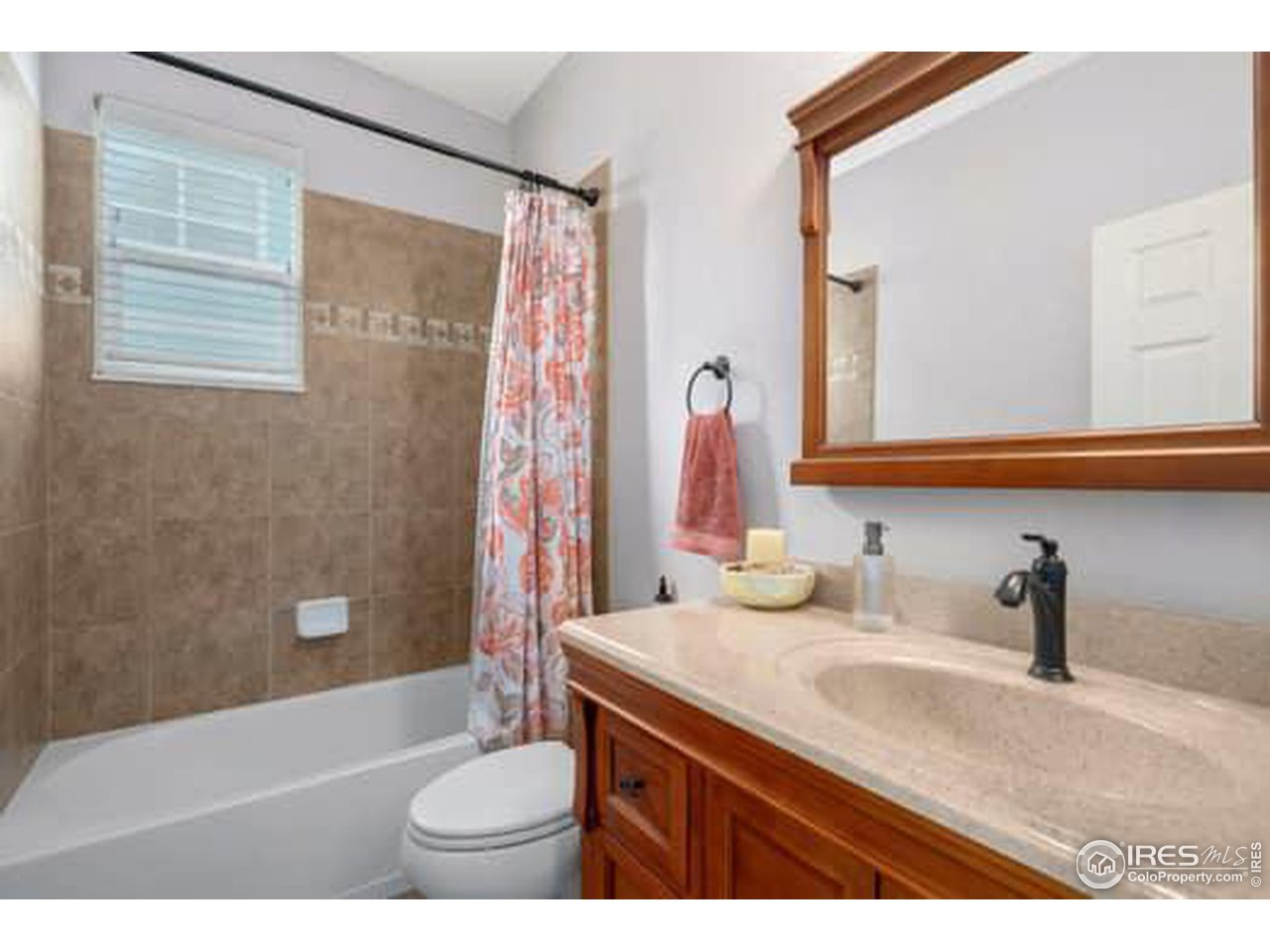 1545 Edenbridge Drive Windsor, CO 80550 - Photo 23 of 28 a bathroom with a granite countertop sink toilet and shower