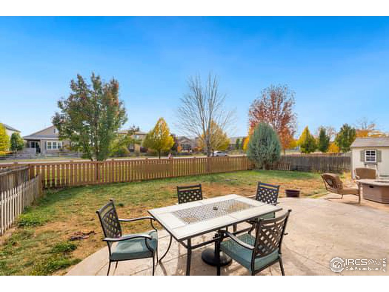 1545 Edenbridge Drive Windsor, CO 80550 - Photo 25 of 28 a terrace with outdoor seating and trees