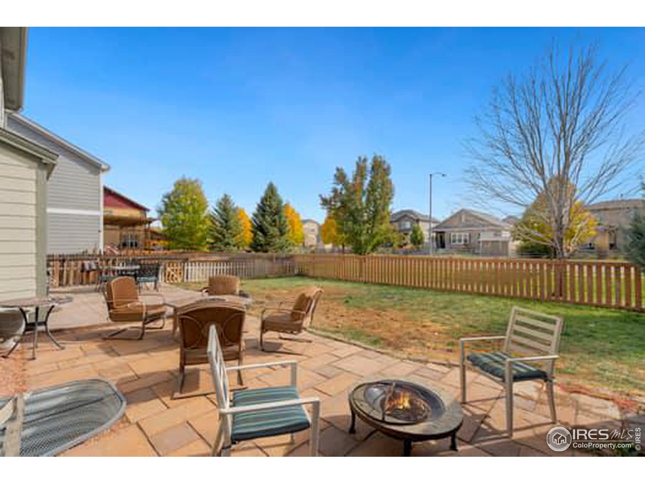 1545 Edenbridge Drive Windsor, CO 80550 - Photo 26 of 28 a view of a lake with couches and wooden floor
