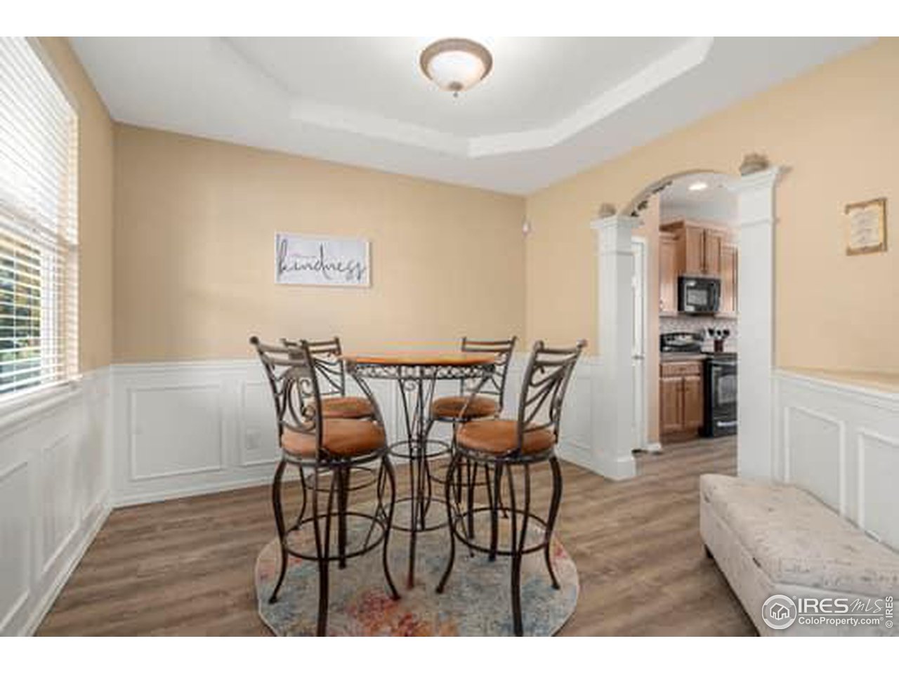 1545 Edenbridge Drive Windsor, CO 80550 - Photo 5 of 28 a view of a dining room with furniture and wooden floor