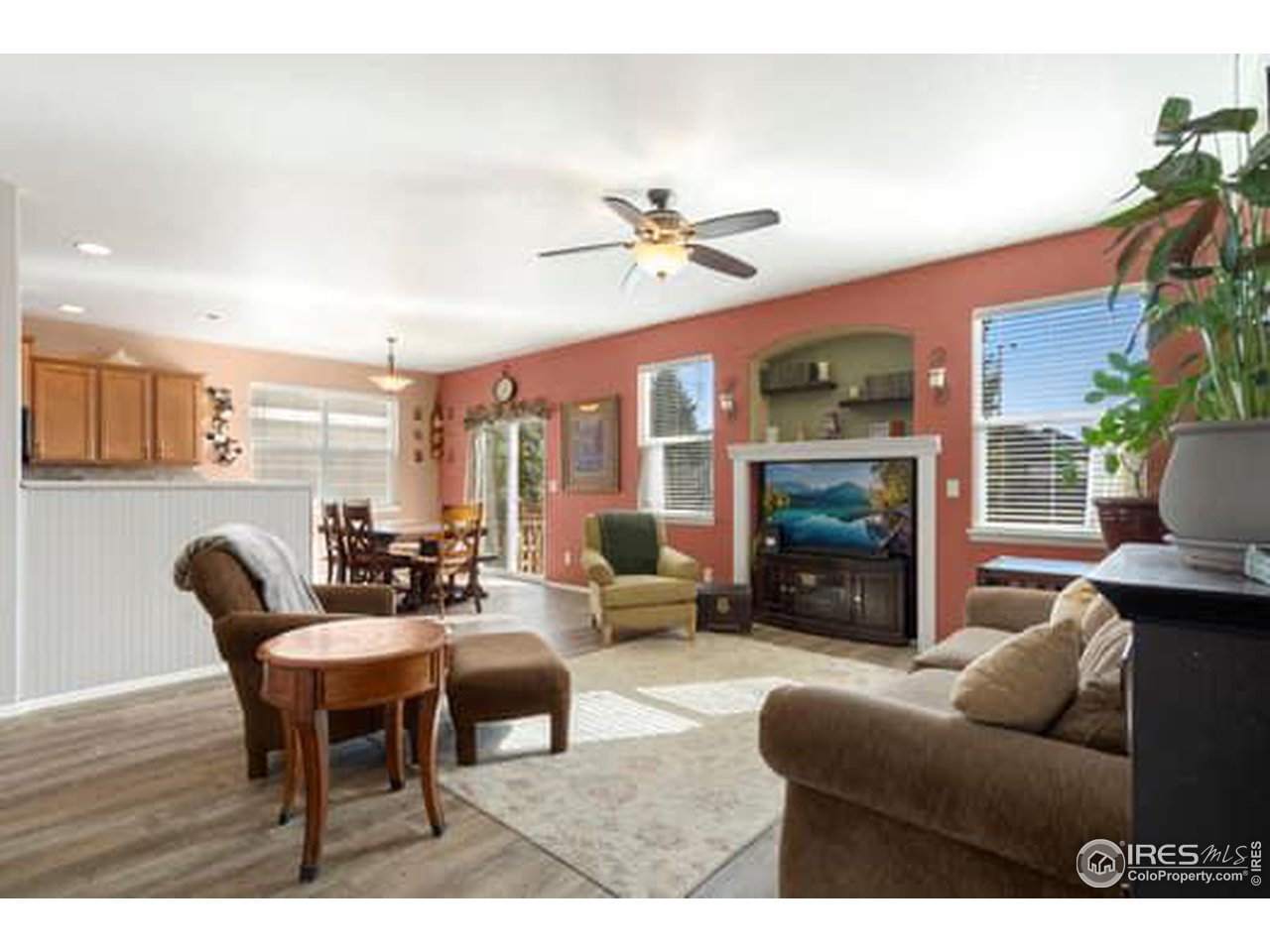 1545 Edenbridge Drive Windsor, CO 80550 - Photo 10 of 28 a living room with furniture a fireplace and a flat screen tv
