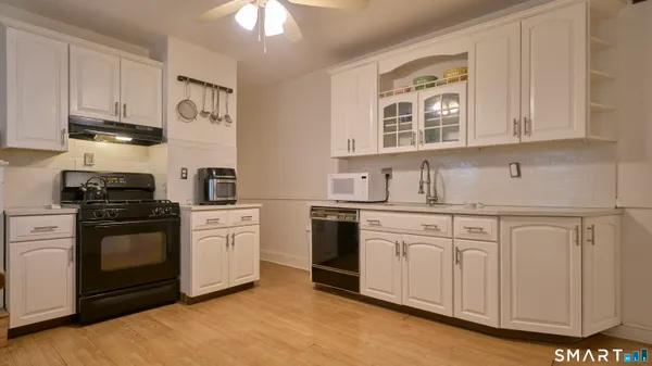 a kitchen with stainless steel appliances granite countertop a stove sink and cabinets