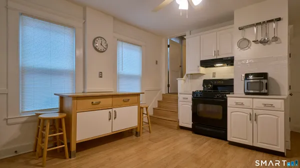 a kitchen with stainless steel appliances granite countertop a stove and cabinets