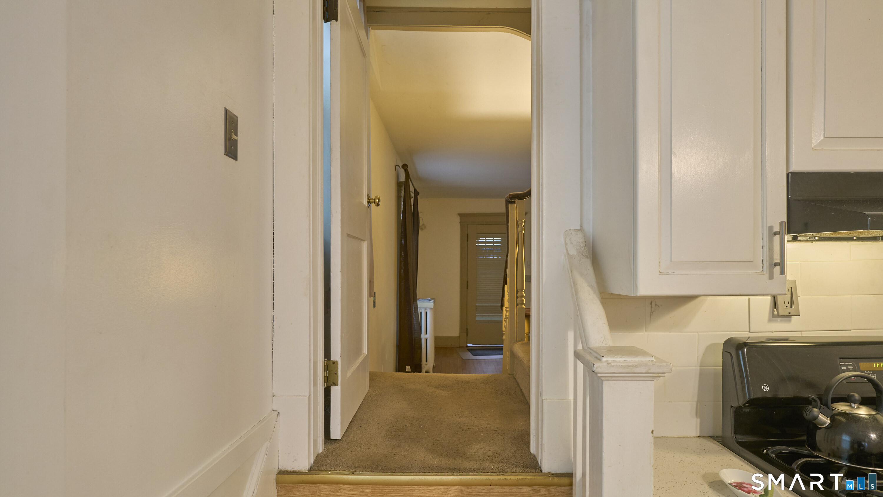 181 Buckingham Street Waterbury, CT 06710 - Photo 16 of 38 a view of a hallway with wooden floor and a bathroom