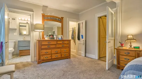 a bedroom with a bed and a car