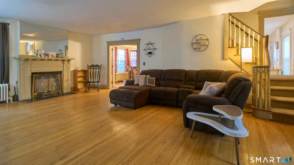 a living room with furniture and a fireplace