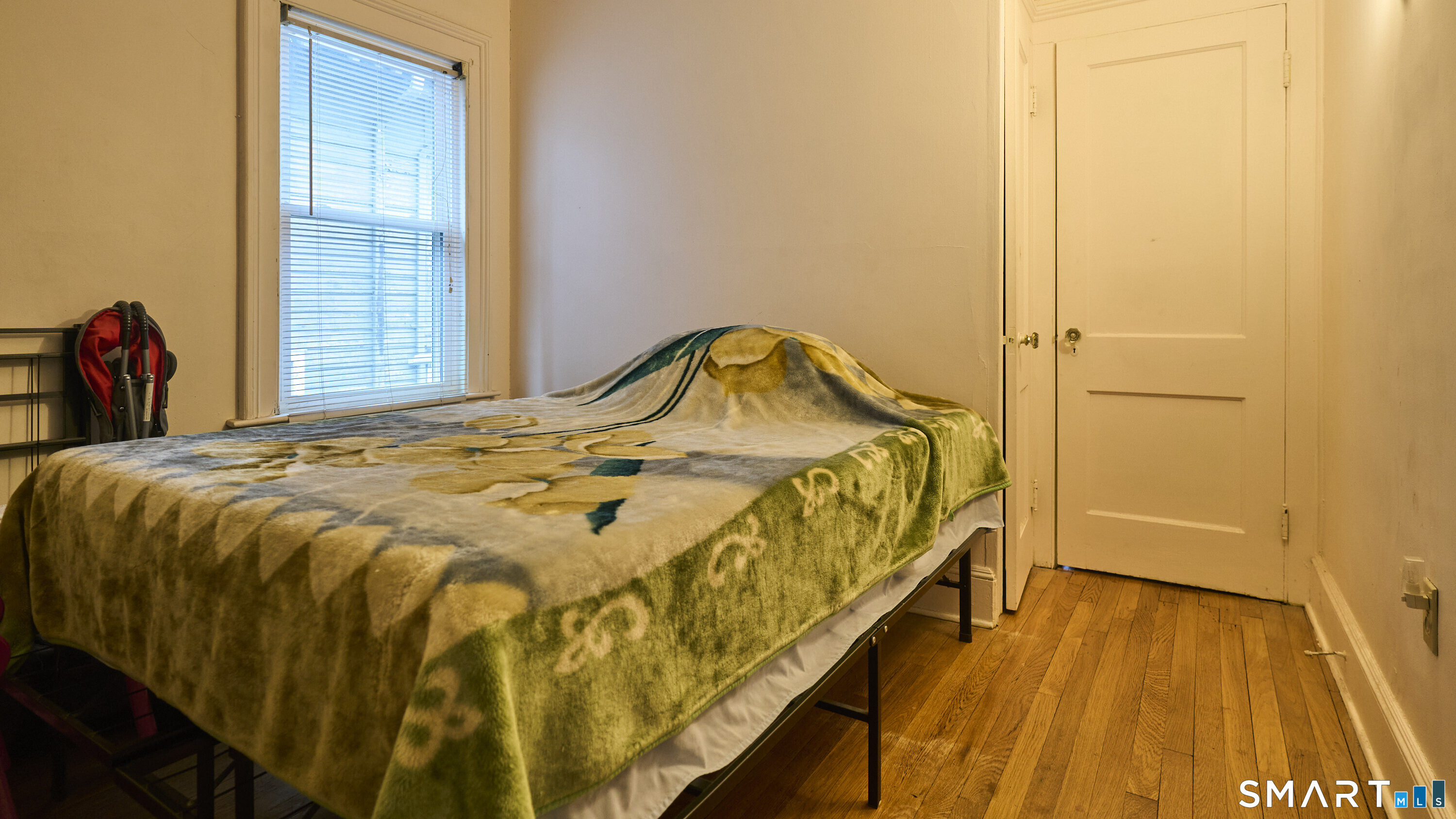 181 Buckingham Street Waterbury, CT 06710 - Photo 24 of 38 a bedroom with a bed and wooden floor