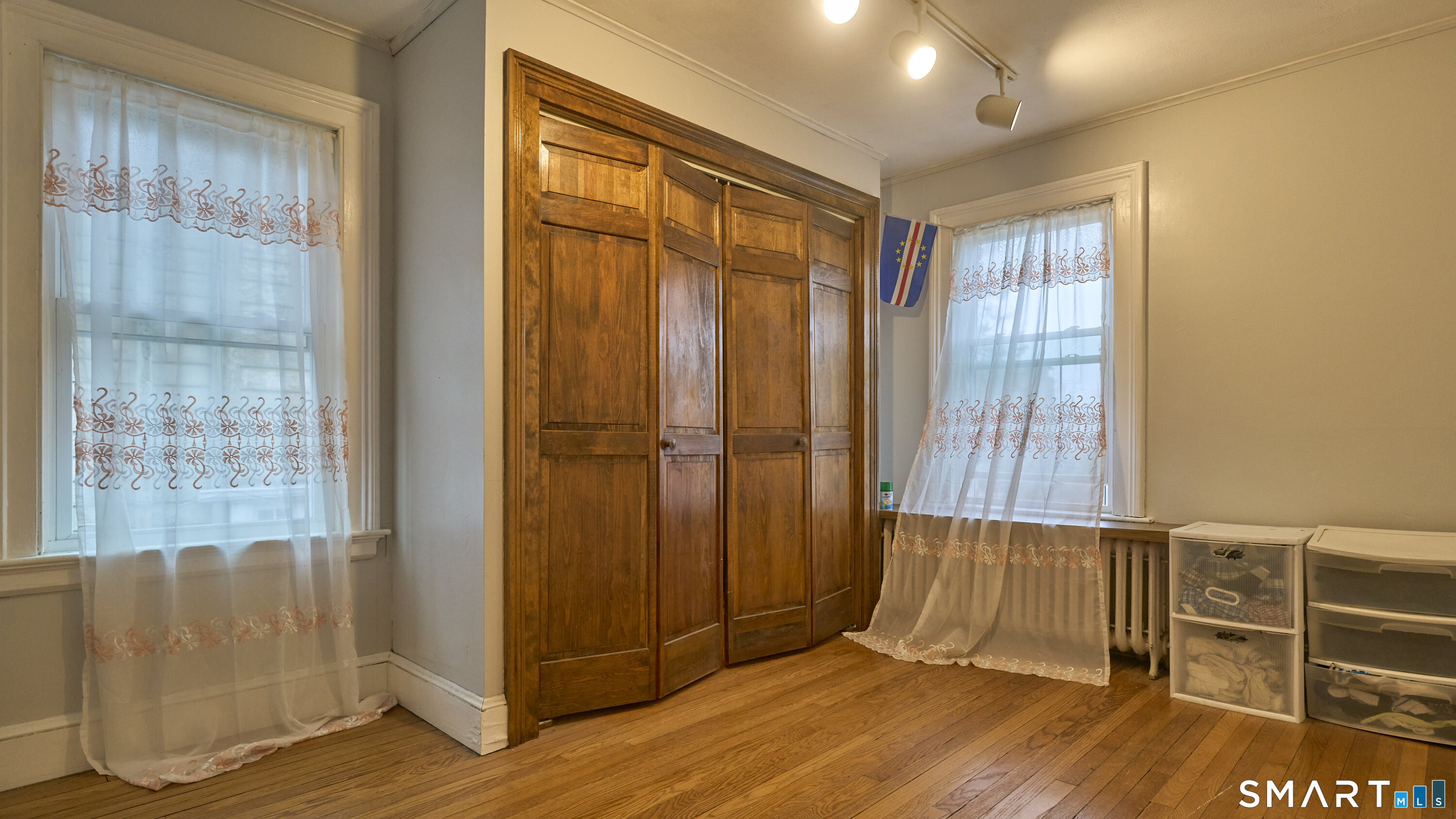 181 Buckingham Street Waterbury, CT 06710 - Photo 25 of 38 an empty room with wooden floor and windows