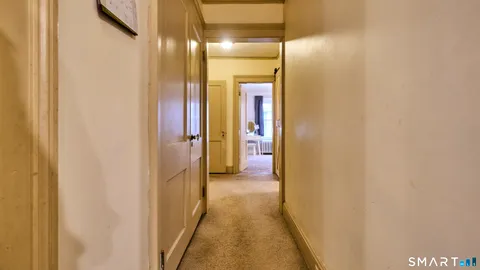 a view of walk in closet with window and wooden floor