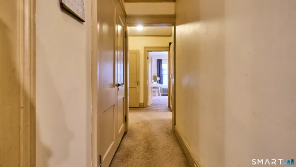 a view of walk in closet with window and wooden floor