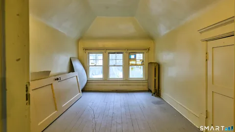 a spacious bathroom with a granite countertop toilet a sink and a large mirror