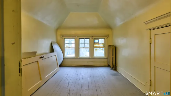 a spacious bathroom with a granite countertop toilet a sink and a large mirror