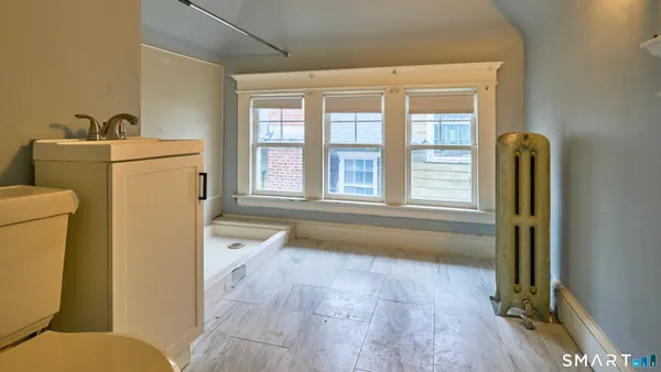 an entryway with wooden floor and cabinet