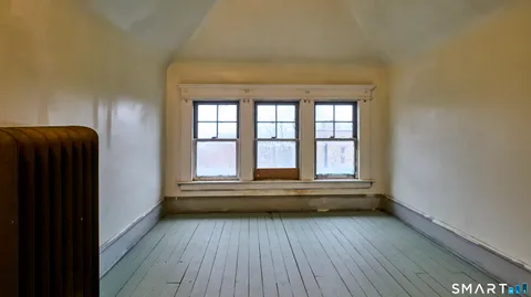a view of hallway with wooden floor